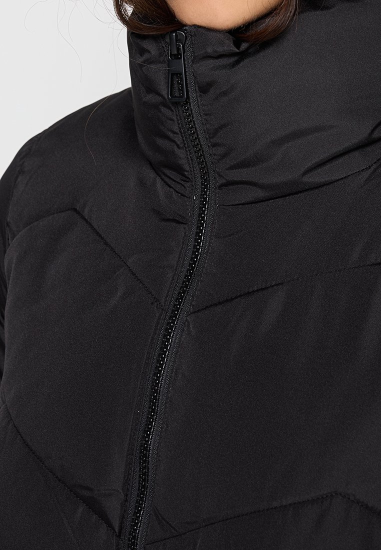 Schwarze Puffjacke mit hohem Kragen, sichtbar mit Reißverschluss und gesteppter Optik, die geometrische Nähmuster aufweist.