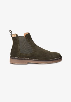 Braune Wildleder Chelsea-Stiefel mit elastischen Seitenpaneelen, einer Zuglasche und einer Gummisohle. Dekorative Naht um den Sohlenrand.