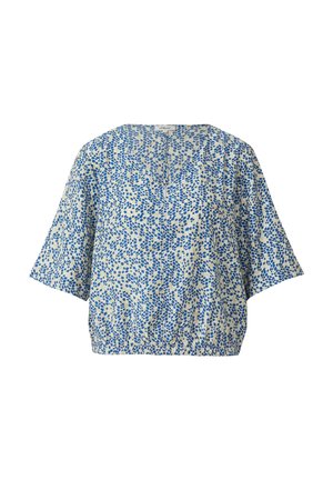 Blouse à manches courtes ample avec motif abstrait de pois bleus sur tissu blanc, col rond et taille élastique.