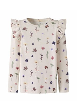 Chemise pour enfants à manches longues de couleur crème avec motifs floraux multicolores et détails à volants sur les épaules, encolure ronde.