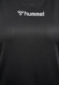 Black athletic shirt with a textured fabric surface, featuring a white "hummel" logo across the chest. Round neck design.