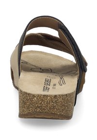 Brown leather sandals with black accents, cork midsole, and a textured insole, featuring a simple strappy design and slight platform.