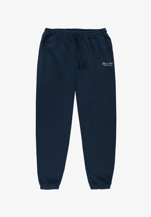 Granatowe spodnie dresowe z elastycznym pasem, sznurkiem, dwoma bocznymi kieszeniami i ściągaczami na kostkach. Mały biały napis na lewym udzie.