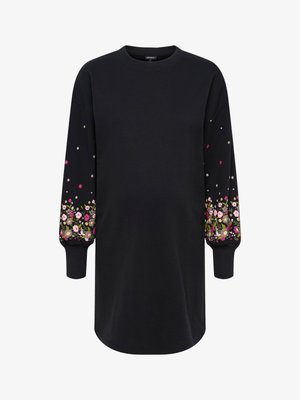 Črna obleka iz puloverja z dolgimi rokavi, ki ima cvetlični vzorec v roza, beli in zeleni barvi na manšetah. Izdelana je iz mehke, teksturirane tkanine.