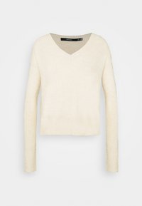 Sweter w kolorze kości słoniowej z dekoltem w serek, długimi rękawami, ściągaczem na dole i mankietach, wykonany z miękkiego, teksturowanego materiału. Krótki fason zapewnia luźne dopasowanie.