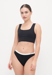 Black bikini set featuring a square-necked top and high-waisted bottom. The bottom has a white waistband with three decorative buttons.