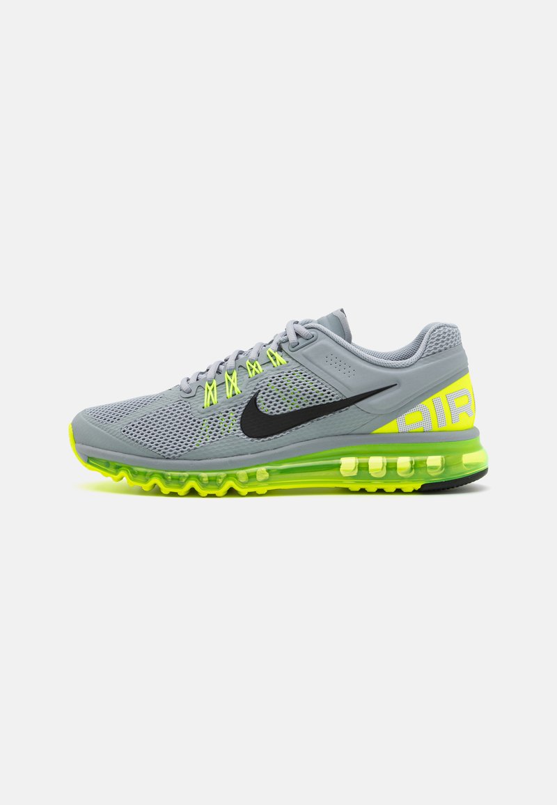 Gray mesh running shoe with black Nike logo, neon yellow accents, cushioned sole, and visible air pocket for enhanced support.