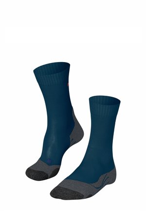 Marineblauwe sokken met ribbels bij de boorden en grijze accenten op de tenen en hielen. Lichtgewicht textiel, gladde textuur en ergonomisch ontwerp.