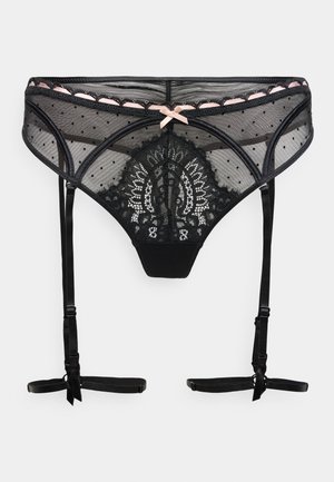 Schwarzer Spitzen-String mit transparentem Mesh, Tupfenmuster und floralen Spitzendetails. Verfügt über verstellbare Träger und eine rosa Schleifenapplikation.