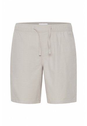 Világos bézs színű, puha anyagból készült rövidnadrág, rugalmas derékkal és húzózsinórral, laza fazonnal. Egyszerű, letisztult dizájn, minta nélkül.