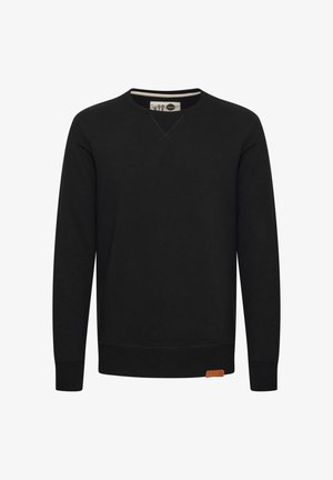 Mustapaita, jossa on pitkät hihat, pyöreä kaula-aukko ja huomaamaton V-muotoilu. Kankaan alaosassa on vaaleanruskea nahkalamelli. Klassinen istuvuus.