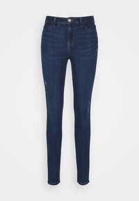 Úzké džíny v tmavě modrém denimu, s mírným vyblednutím a zdrsněnými detaily. Klasický pětikapsový design s knoflíkovým zapínáním v pase.