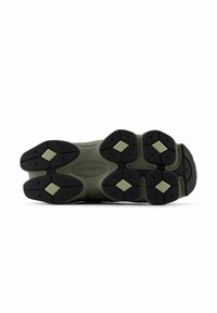 Black and green athletic shoe sole featuring textured rubber, diamond-shaped patterns, and a series of raised grips for traction.