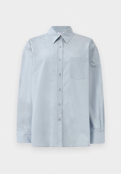Light blue long-sleeve button-up shirt with pointed collar and chest pocket, laid flat on a white background.