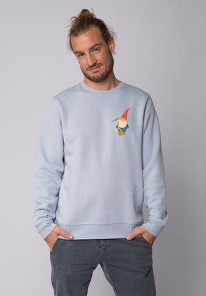 Helle blaue Sweatshirt mit einem bunten Gartenzwerg-Motiv auf der Brust. Weicher Stoff, runder Ausschnitt und gerippte Bündchen und Saum.