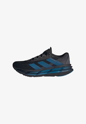 Chaussure de course Adidas noire et bleue avec empeigne en mesh, trois bandes latérales et semelle coussinée portant l'inscription "Repetitor".