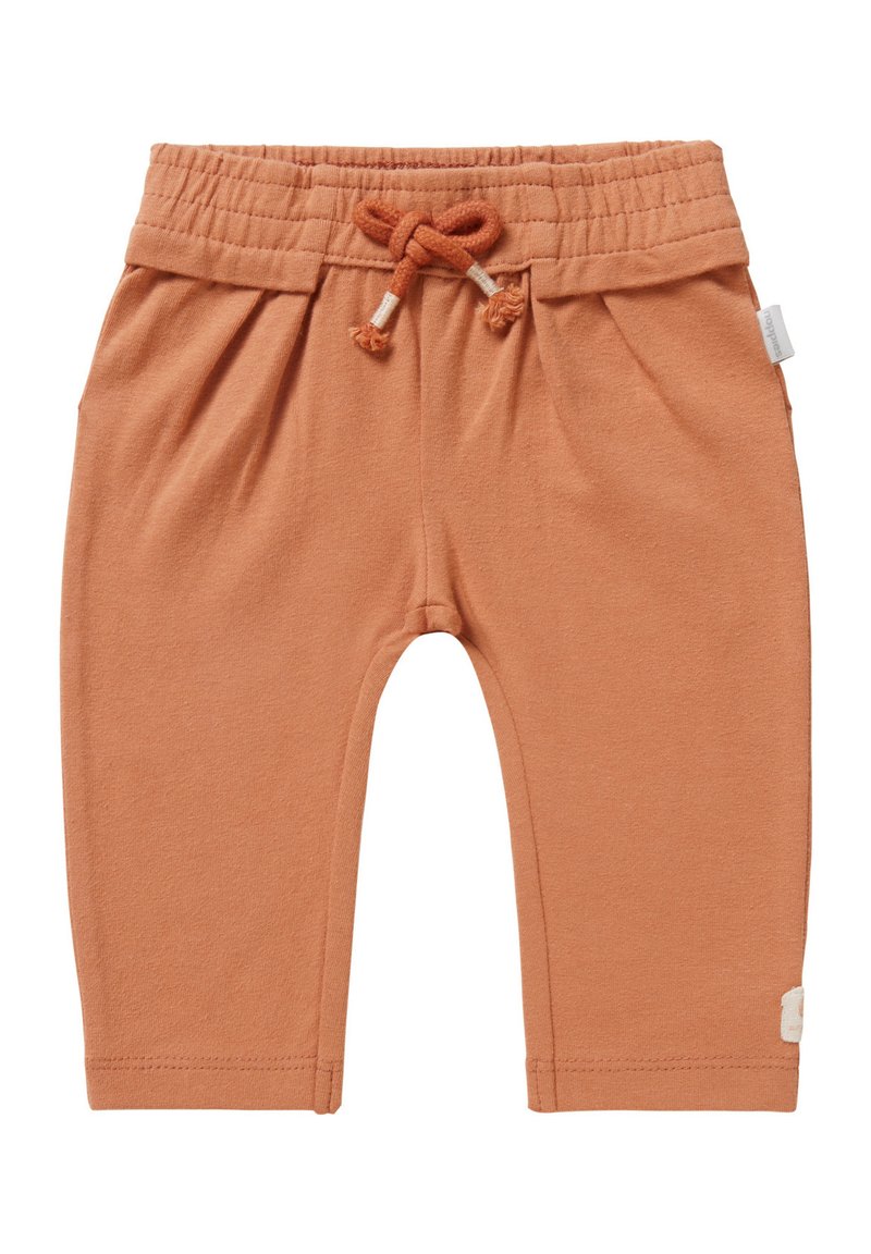 Rude bawełniane spodnie w kolorze rdzawym z elastycznym paskiem w talii, regulowanym sznurkiem oraz bocznymi pliskami. Posiadają małą metkę na lewym dolnym brzegu.