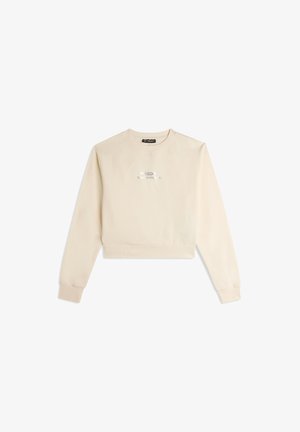 Sweatshirt beige court en tissu doux, avec un col rond, des poignets côtelés et un texte brodé à l'avant.