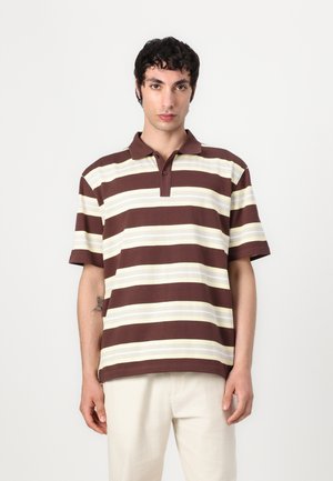 Brown and cream striped polo shirt with a collared neckline and short sleeves, featuring two buttons on the placket. Smooth cotton fabric.