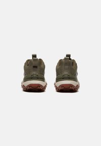 Groene sportieve schoenen met gestructureerde mesh bovenkant, versterkte hak, opvallende gripzool en trekflappen aan de achterkant voor gemakkelijk aan- en uittrekken.