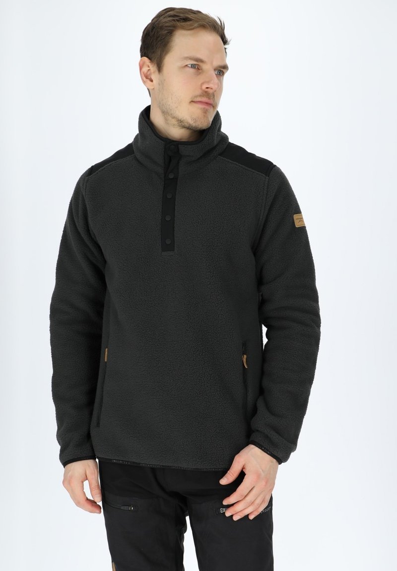 Pullover in pile nero da uomo con colletto alto, patta dei bottoni anteriore e tasche laterali; presenta accenti neri sulle spalle e una toppa con logo beige.