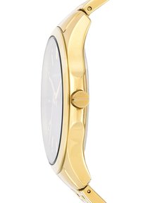Gold-tone wristwatch with a curved polished case, flat glass, minimal dial markings, and a push-button crown on the side.