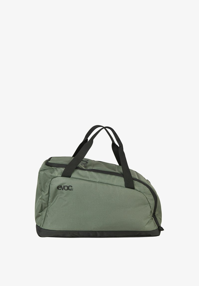 Sac de sport souple vert et noir avec deux poignées noires et une fermeture éclair sur le dessus, arborant le logo "EVOC" sur le côté.