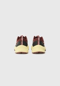 Sport shoes with a maroon upper, black accents, and yellow outsole. Features a textured heel and pink pull tab for ease of wear.