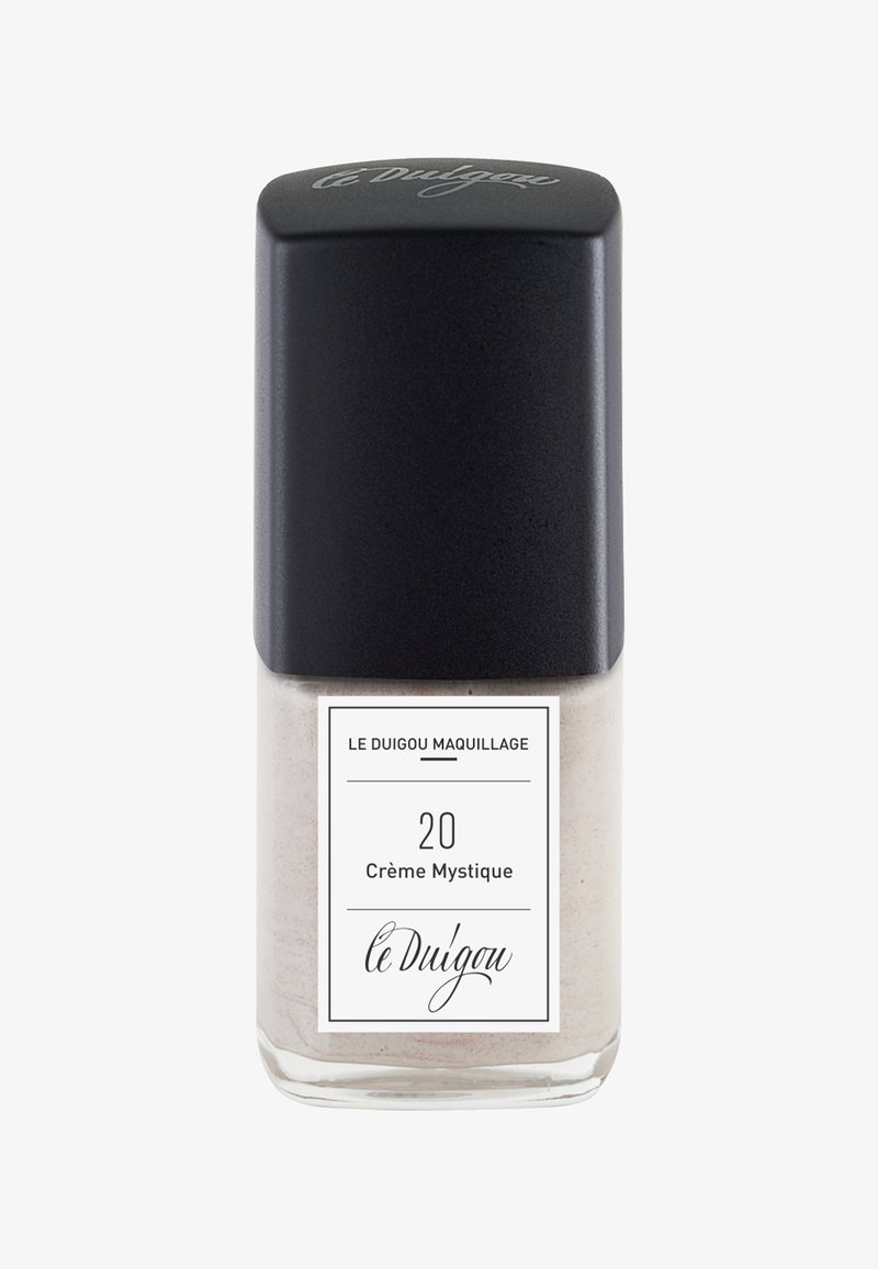 Cremefarbener Nagellack in einer klaren Glasflasche mit mattschwarzem Deckel. Das Etikett hat einen weißen Hintergrund mit schwarzem Text und Akzenten.