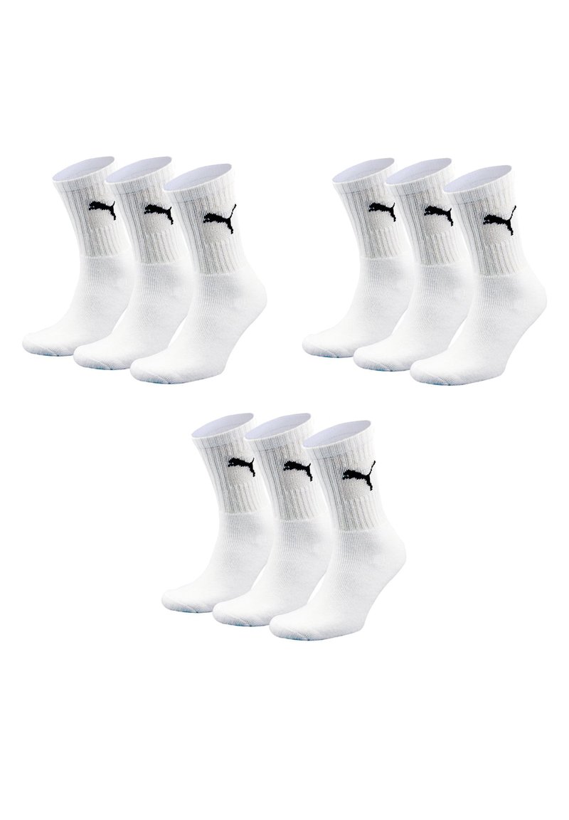 Four pairs of white cotton crew socks with textured ribbing, featuring a black Puma logo on the front.