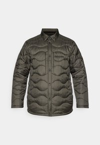 Chaqueta acolchada en verde oscuro, con un diseño acolchado y patrones ondulados, cuello con solapa y cierres de botón en la parte delantera.