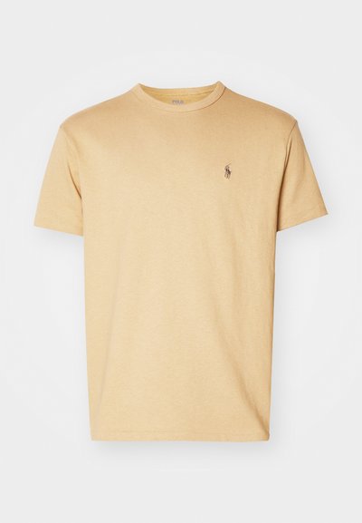 Short-sleeve yellow cotton t-shirt featuring a crew neckline and a small embroidered logo on the left chest. Soft, smooth texture.