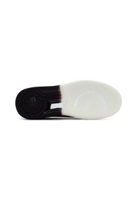 Semelle de sneaker noir et blanc avec caoutchouc texturé, présentant un design de logo floral et une semelle intermédiaire blanche lisse.