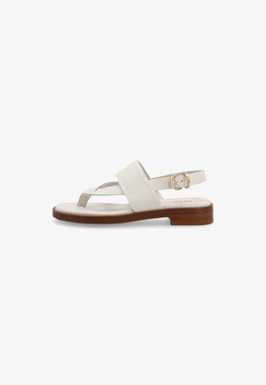 Sandalia plana de cuero blanco con suela de madera, correa ajustable en el tobillo y lazo para el dedo del pie sobre fondo blanco.