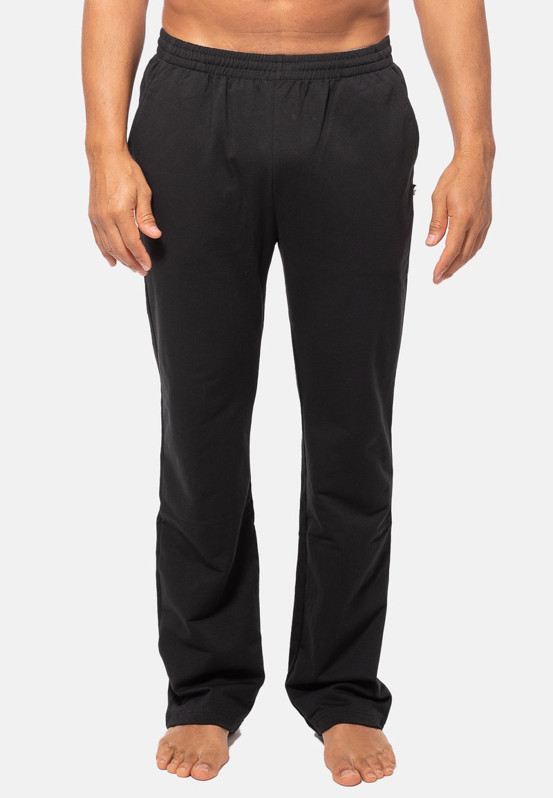 Zwarte, lichte sweatpants met een elastische tailleband en een rechte pijpdesign. Gemaakt van zachte stof, zonder zichtbare patronen of accenten.