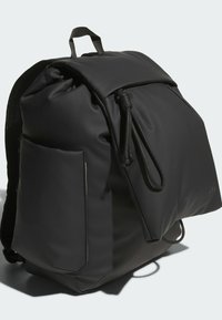 Black waterproof backpack featuring a roll-top closure, adjustable drawstring, and a side mesh pocket. Smooth texture with minimalist design.