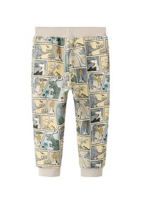 Spodnie dresowe z bawełnianej mieszanki w jasnobeżowym kolorze z nadrukiem dinozaura w stylu komiksowym. Posiadają elastyczny pas i ściągacze przy kostkach.