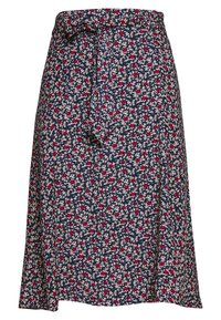 Jupe marine avec un motif floral en rouge et crème. Elle présente une taille nouée et un design fluide, fabriquée en tissu léger.