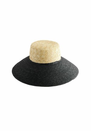 Chapeau de paille à large bord, avec une couronne couleur tan naturel et un bord tissé noir, présentant une texture lisse et un design circulaire.