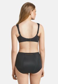 Black lingerie set featuring a smooth, stretchy bra with adjustable straps and a high-waisted bottom. Simple design with no patterns.
