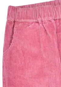 Pink corduroy pants featuring vertical ribbed texture, elastic waistband, and side pockets. The fabric appears soft and plush.