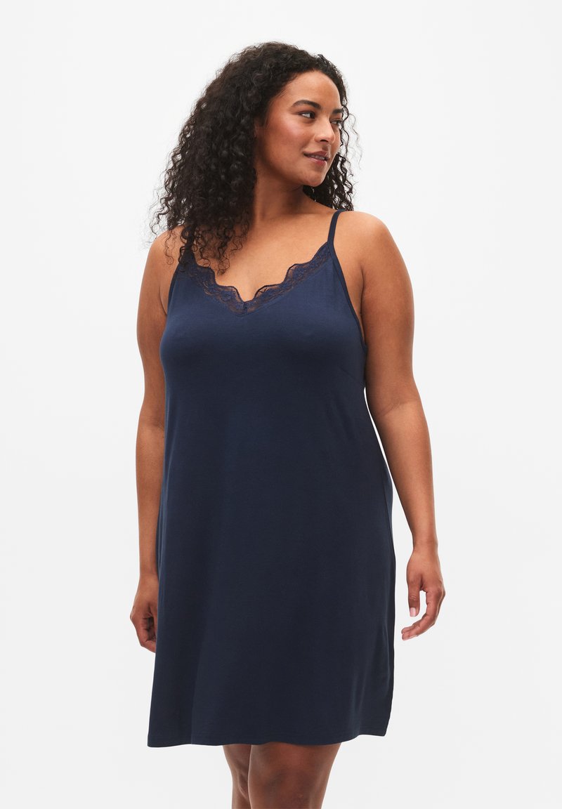 Camisola navy con spalline regolabili, caratterizzata da un bordo in pizzo scallop lungo il collo e un design morbido e fluido.
