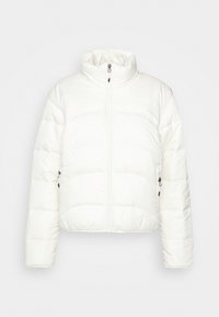 Veste blanche matelassée avec col montant, fermeture éclair à l'avant et poches latérales zippées, présentée sur un fond uni.