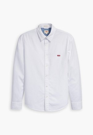 White long-sleeve button-up shirt made of cotton. Features a pointed collar and a small red Levi's logo on the left chest. Smooth texture.