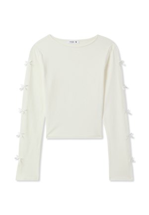 Biała bluzka z długim rękawem, wykonana z miękkiego materiału, z okrągłym dekoltem i małymi kokardkami na rękawach jako detal. Krótki krój.