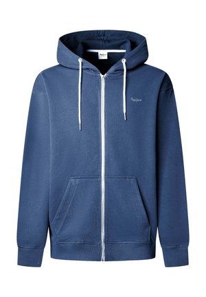 Tumši zils kapučjakas tips ar rāvējslēdzēju, auklām, priekšējām kabatām, ribotu aproču maliņu un nelielu logo krūtīs. Izgatavots no mīksta, teksturēta auduma.