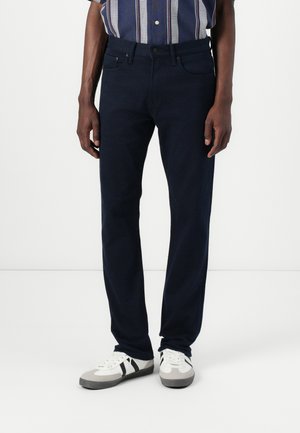 Navy blue jeans in a straight-leg fit, made from denim with a slight stretch. Features a classic five-pocket design and a button closure.