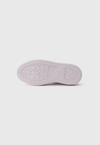 Light pink rubber shoe sole with a textured surface, featuring a diamond pattern, ridges, and a rounded heel for grip and flexibility.