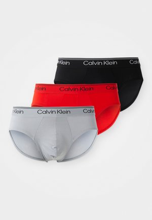 Men's briefs in gray, red, and black; elastic waistband with "Calvin Klein" logo. Smooth fabric with a fitted design.