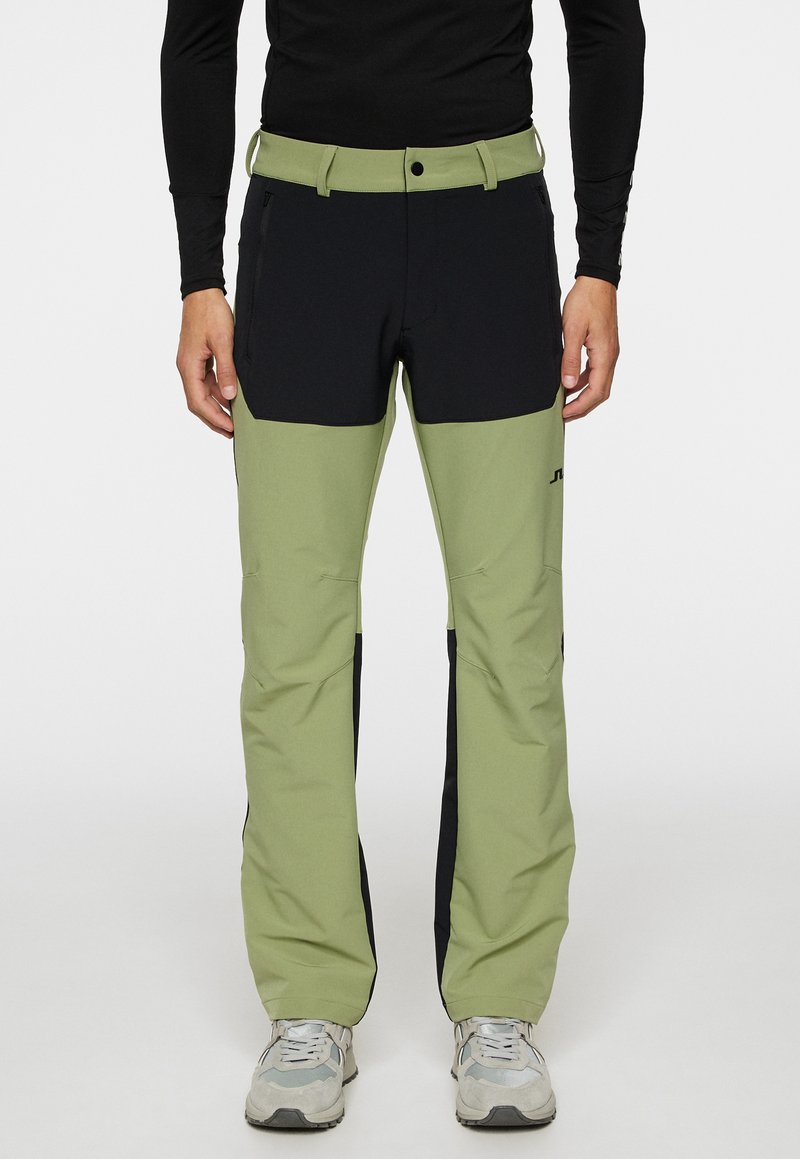 Vihreät ja mustat ulkoiluhousut, joissa on tyylikäs muotoilu ja kestävä kangas. Ominaisuuksiin kuuluu useita taskuja ja istuva vyötärö.